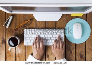 stock-photo-businesswoman-using-pc-computer-on-her-office-table-215226196